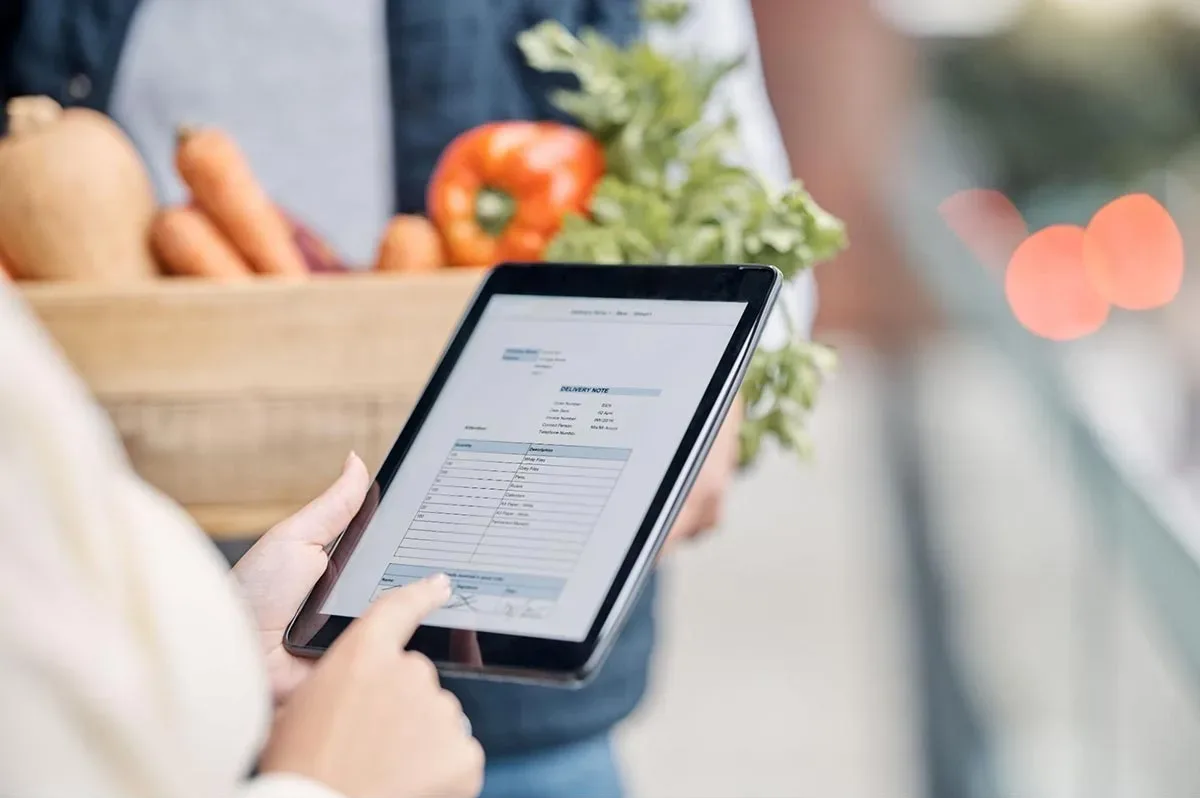 A restaurant manager uses a tablet to automate various management tasks.