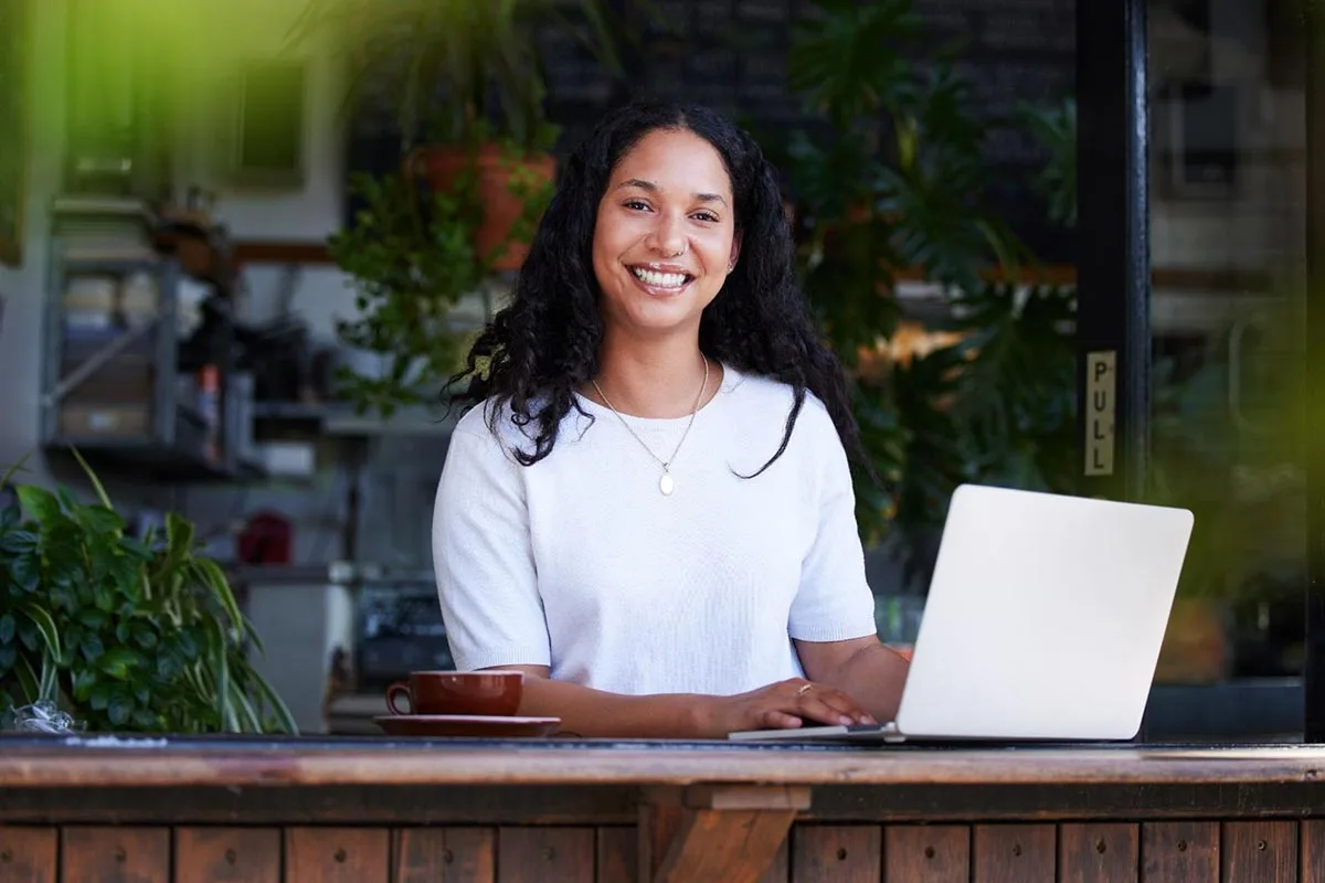 A restaurant owner uses a laptop to set up a free Yelp business page.