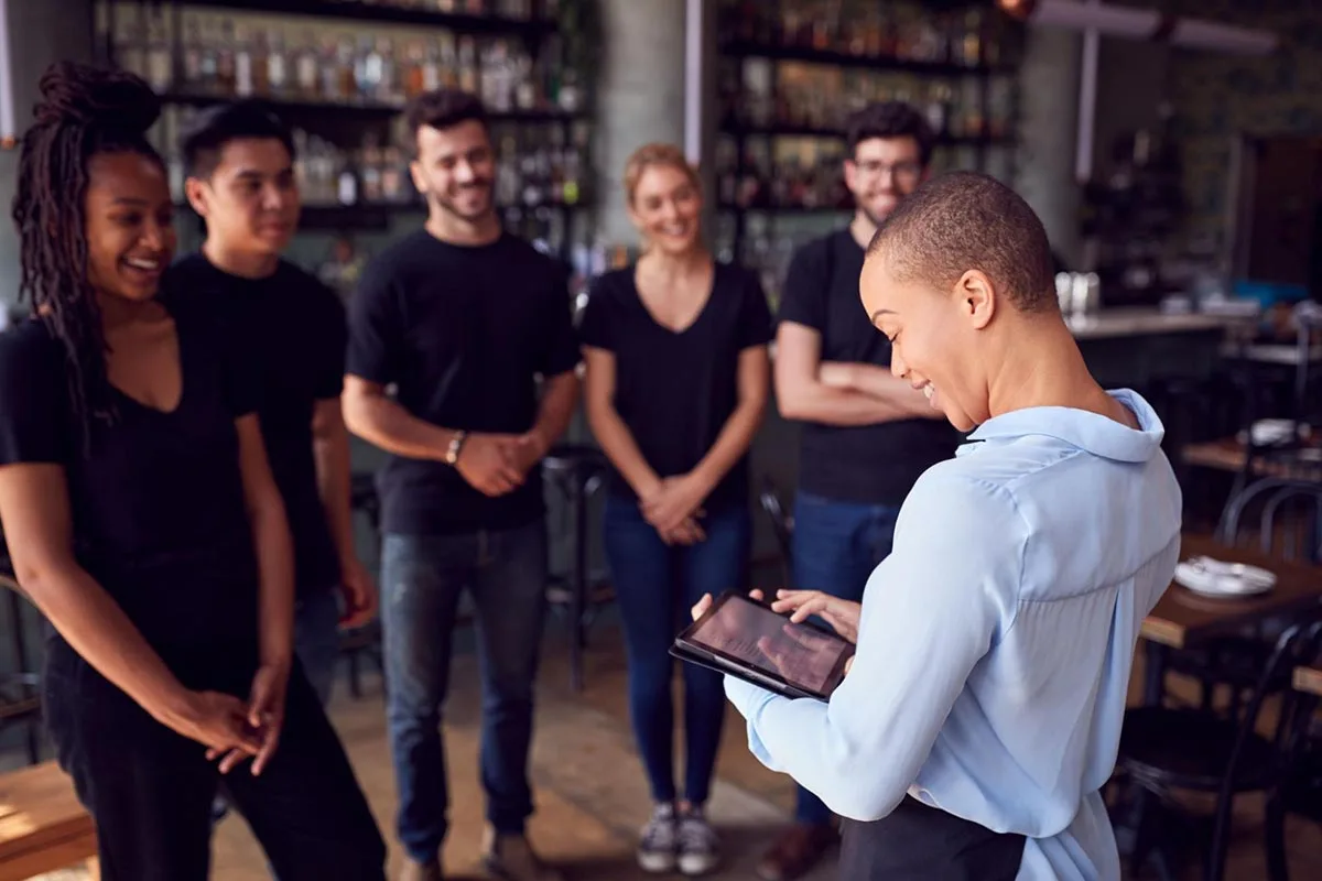 Restaurant staff members gathered for a team meeting.