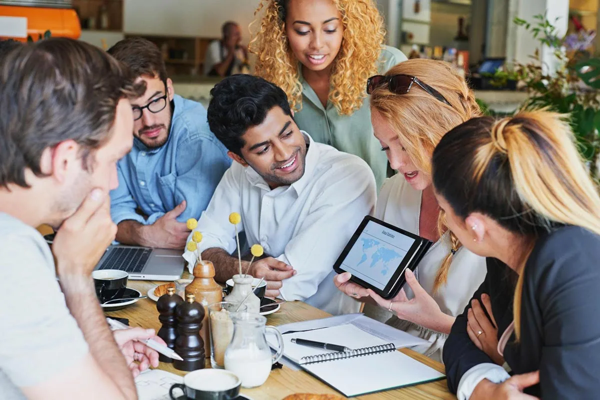 A social media team discussing how to utilize influencers during a meeting.