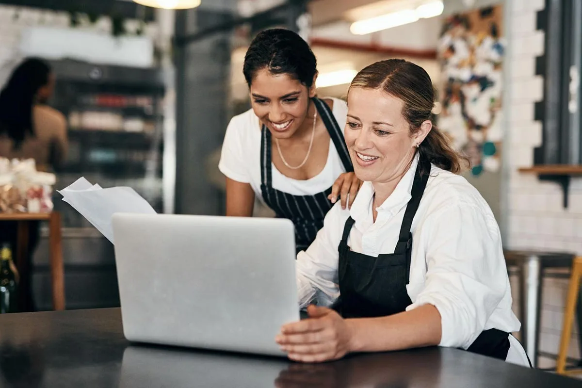 Joint restaurant owners conducting an audit together inside their restaurant.