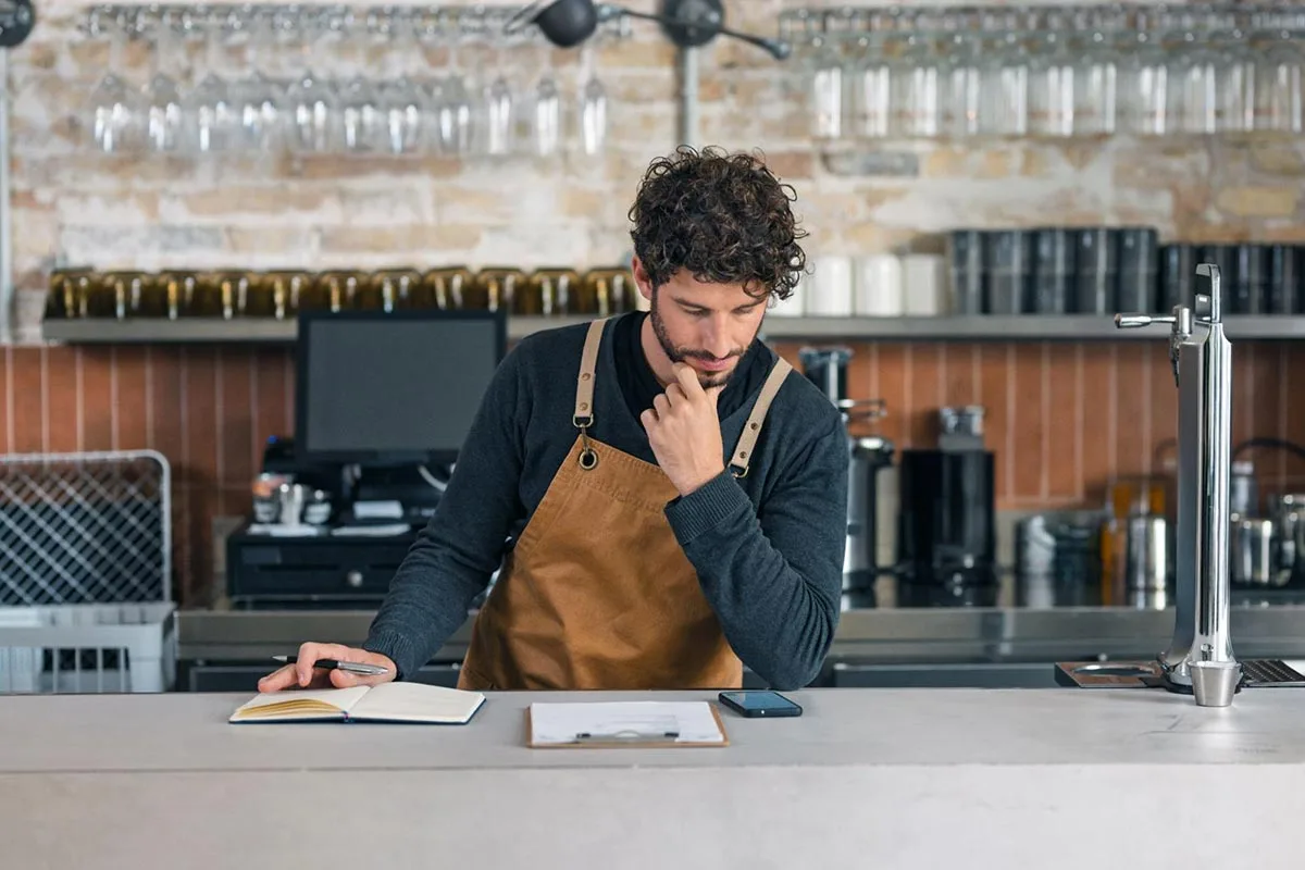 A restaurant manager reviews an audit checklist .