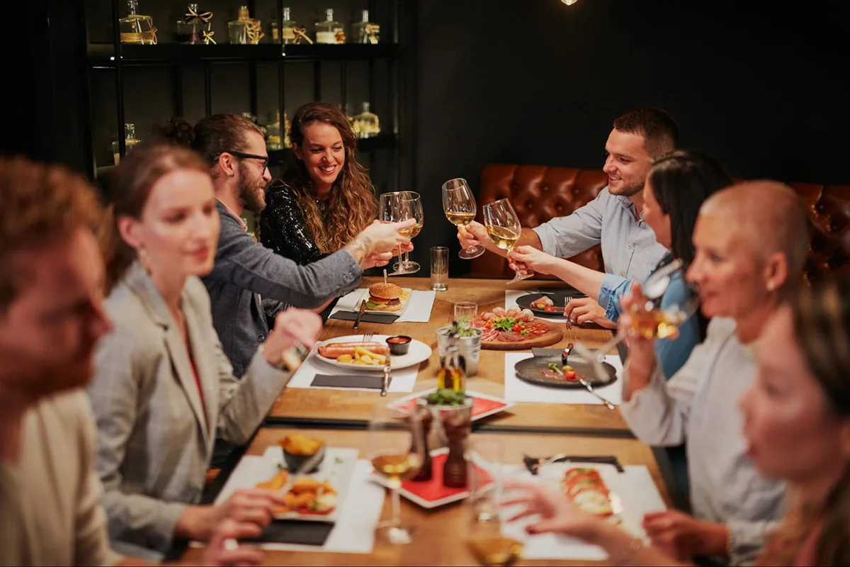 Friends enjoying a meal together from a festive holiday menu.