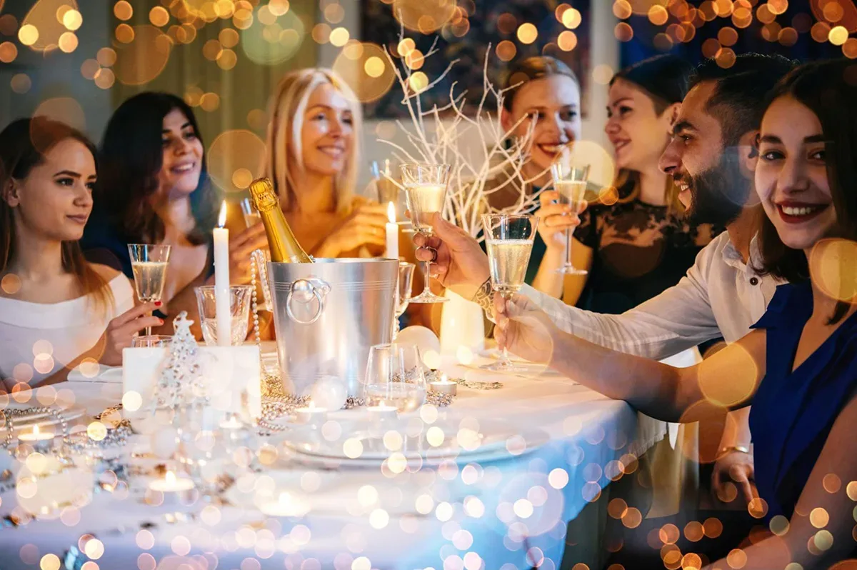 Friends celebrating with a champagne toast at a restaurant.