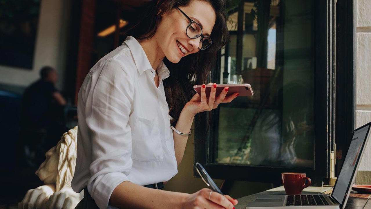 A restaurant owner manages an AI-powered answering service on a digital device.