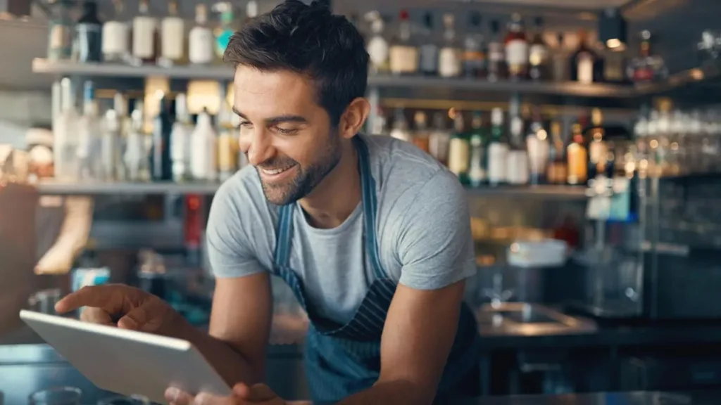 A restaurant manager uses an AI agent on a tablet to streamline operations.