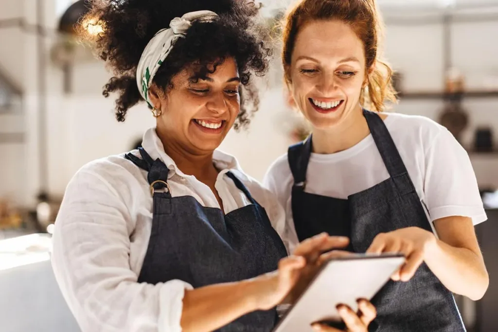 Restaurant staff member using an AI agent on a tablet.